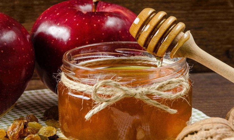 Honey in a jar honey spoon apple